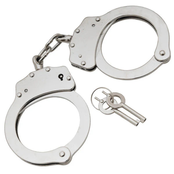 Metallic handcuffs with a key on a white background